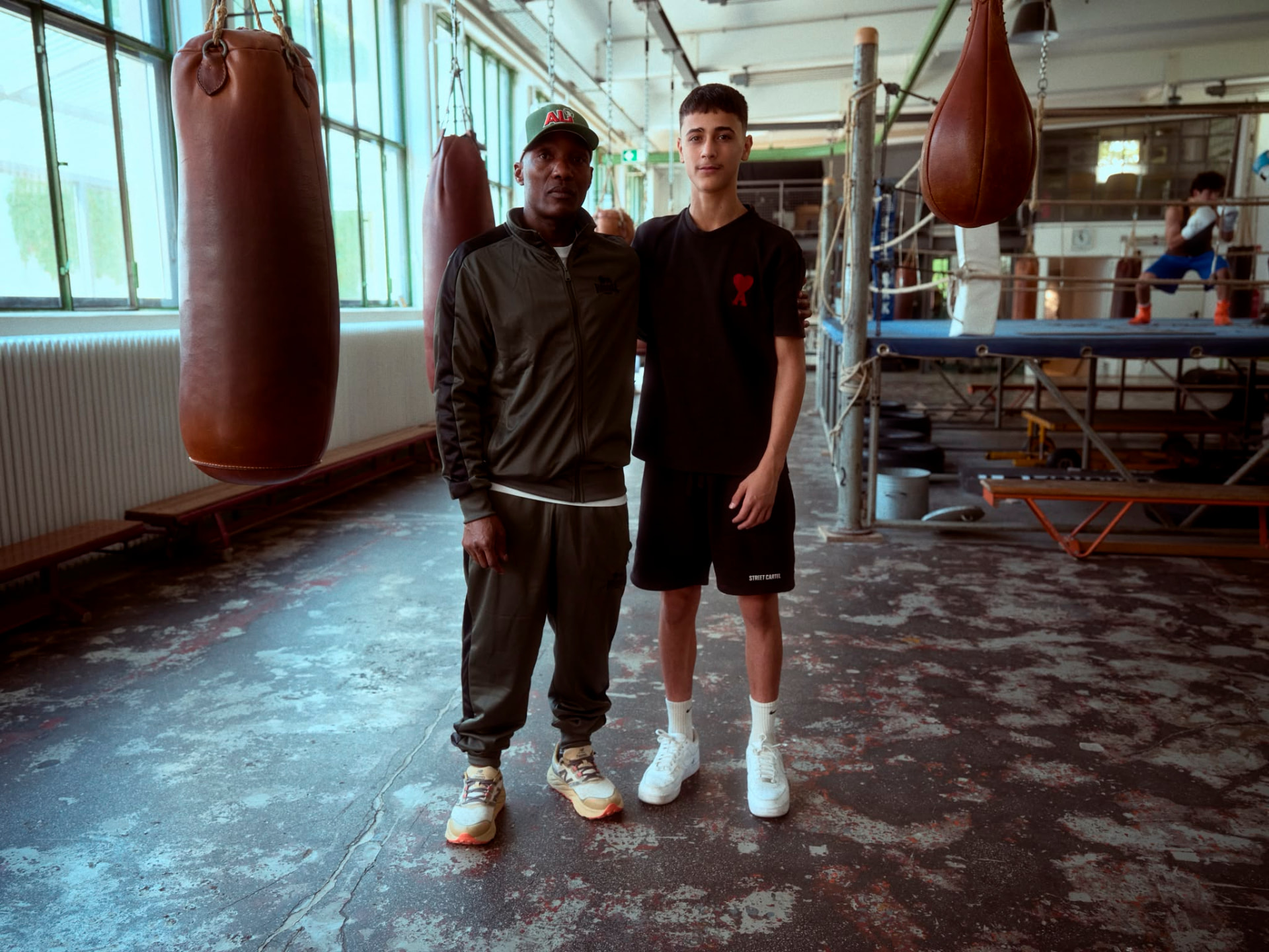 Coach Walu with a young boxer at Boxwerk Munich